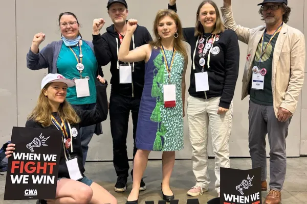 Six UCWGA Members at the CWA Convention. One is holding a sign that says: "When We Fight We Win".