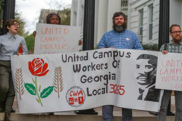 UCWGA members hold banner at a rally